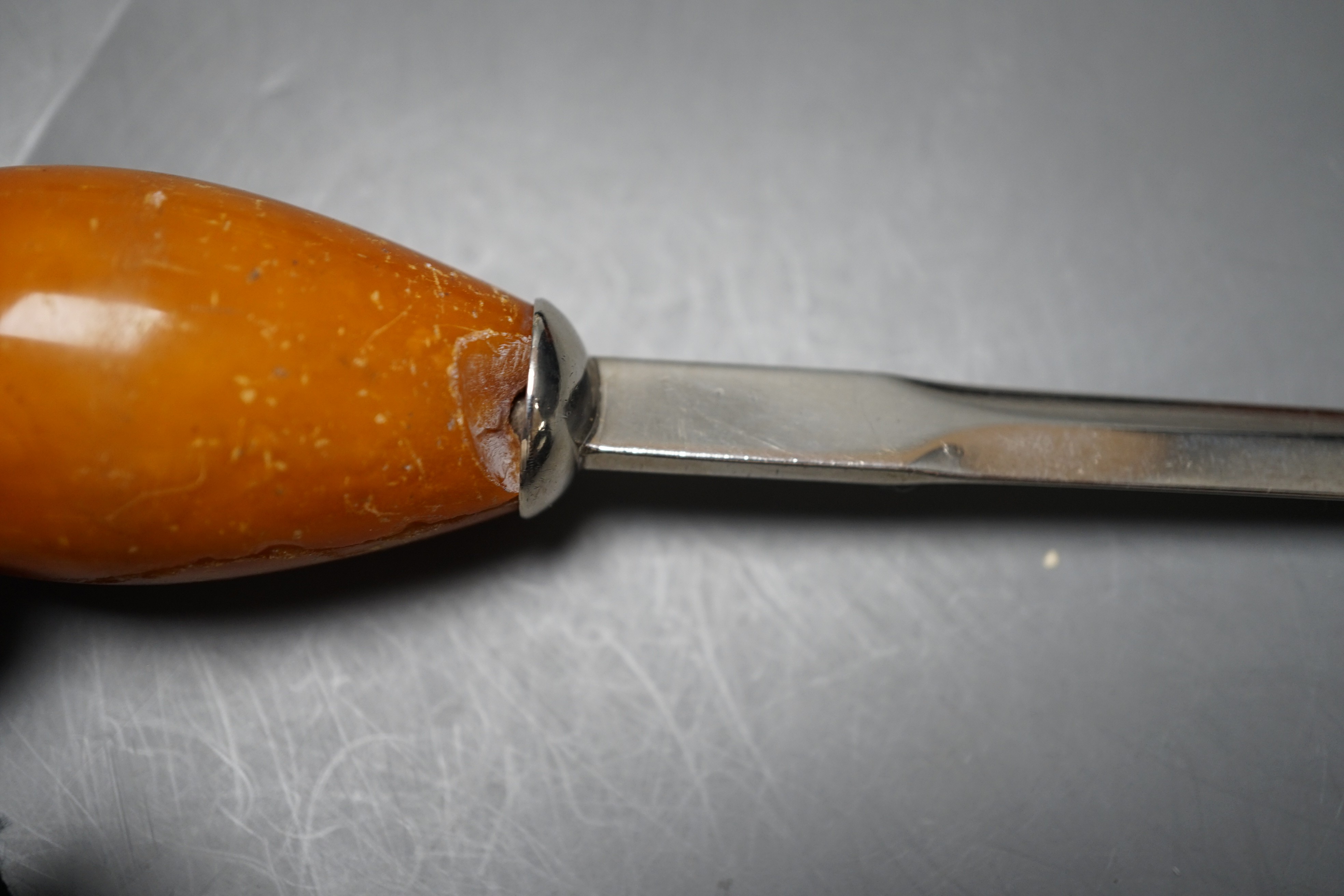 Two tortoiseshell boxes, an onyx cigarette box (does not fit case) and a Baltic amber handled silver paperknife